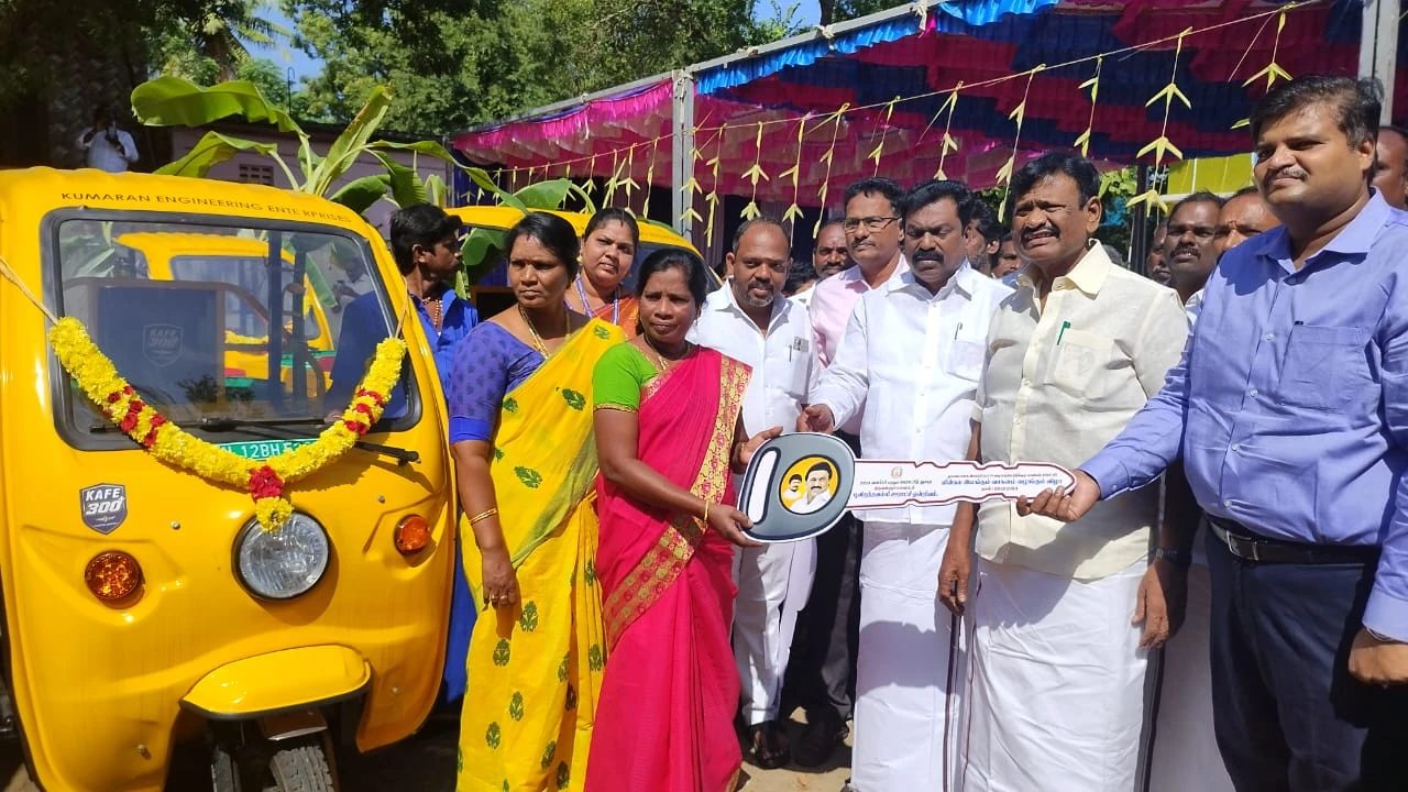 Ceremonial key handover to a recipient beside a garlanded KAFE 300+