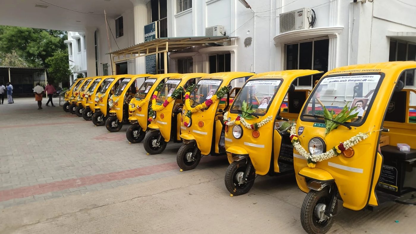Row of garlanded KAFE 300+ vehicles outside a government office